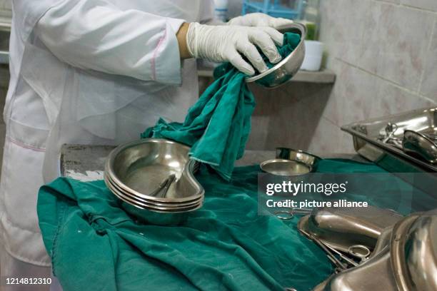 May 2020, Egypt, Giza: A picture made available on 23 May 2020 shows a medic disinfecting surgical instruments at the 6th Of October Central...