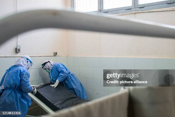 May 2020, Egypt, Giza: A picture made available on 23 May 2020 shows medics disinfecting a hospital bed at the 6th Of October Central Hospital, which...