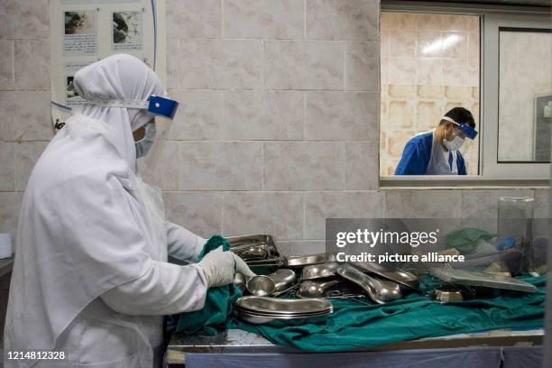 May 2020, Egypt, Giza: A picture made available on 23 May 2020 shows medics disinfecting surgical instruments at the 6th Of October Central Hospital,...