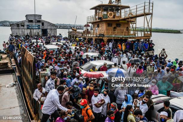 Ferry is seen carry crowds of people and a number of vehicles during Eid al-Fitr. Migrant people get onto an overcrowded ferry to travel home for Eid...