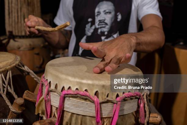 Alexandre Garnize, musician, historian, candomblecist and founder of the group "Tambores do Olokun" plays percussion instruments in his home during...