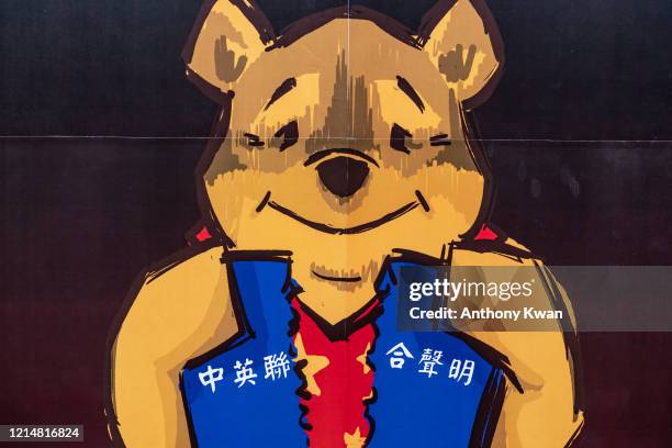 Placard of Winnie the Pooh representing Xi Jinping is held by pro-democracy supporters during a rally outside of Chineses Liaison Office on May 24,...