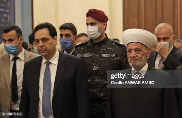 Lebanons Prime Minister Hassan Diab and Grand Mufti Sheikh Abdel-Latif Derian arrive for a morning prayer to celebrate the Eid al-Fitr holiday at...