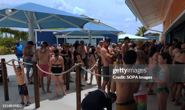 People wait in a queue at a snack bar at Island H2O Live! water park as the attraction becomes the only major water park in the Orlando area to...