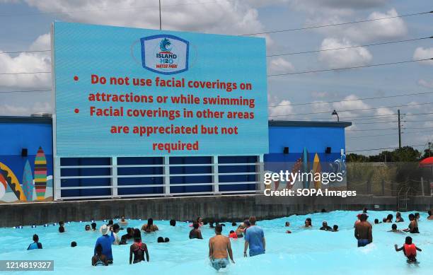 An advisory about face coverings is displayed at the wave pool at Island H2O Live! water park as the attraction becomes the only major water park in...