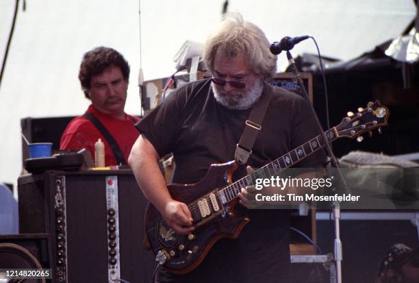 Guirar technician Steve Parish watches Jerry Garcia of the Grateful Dead perform at Laguna Seca Raceway on August 1, 1988 in Monterey, California.