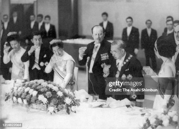 Paraguayan President Alfredo Stroessner toasts glass with Emperor Hirohito , Empress Nagako , Crown Prince Akihito , Crown Princess Michiko and...