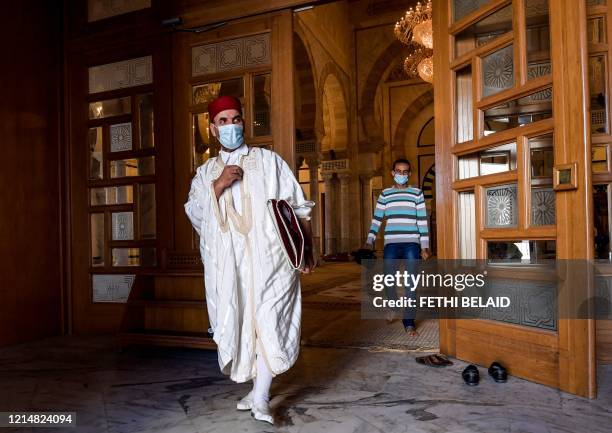 Tunisian worshipper clad in mask due to the COVID-19 coronavirus pandemic exits Malek Ibn Anas mosque in Carthage, east of the capital, after prayer...