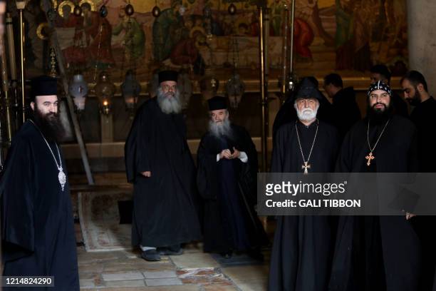Greek Orthodox, Coptic Orthodox, Armenian, and Franciscan clergymen stand inside the Church of the Holy Sepulchre in Jerusalem's Old City on May 24...