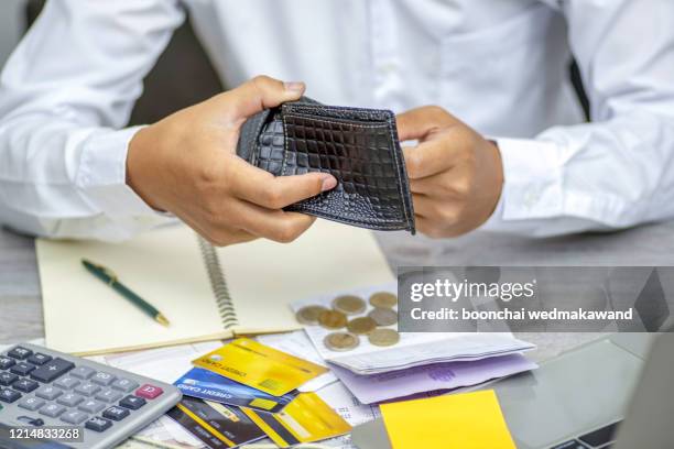 poor asian man hand open empty purse looking for money having problem bankrupt broke after credit card payday - different loans stockfoto's en -beelden