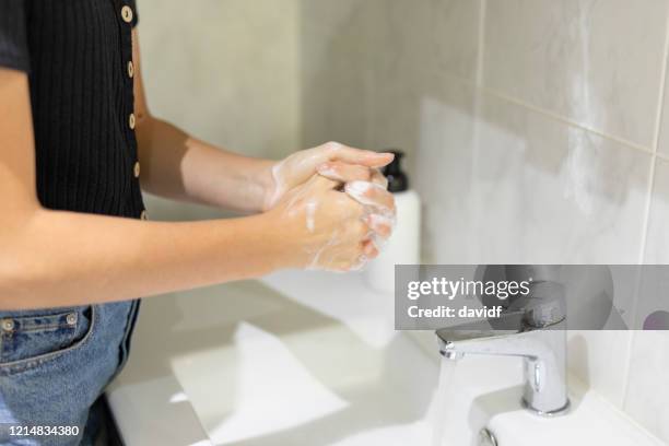 teenage girl washing her hands in the bathroom - washing hands close up stock pictures, royalty-free photos & images