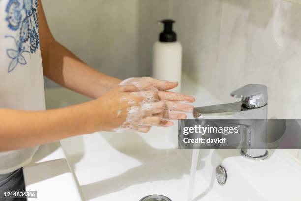 teenage girl washing her hands in the bathroom - washing hands close up stock pictures, royalty-free photos & images
