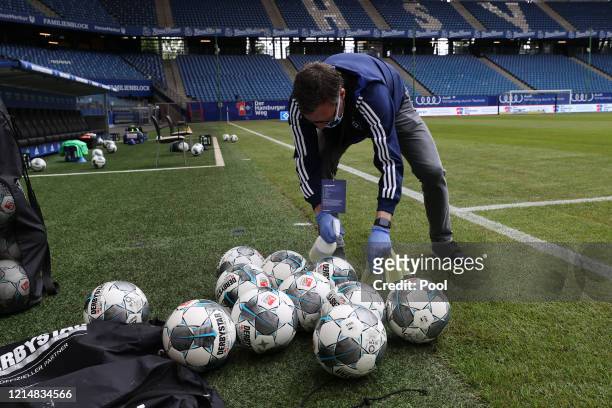 Match balls are sanitised prior to the Second Bundesliga match between Hamburger SV and DSC Arminia Bielefeld at Volksparkstadion on May 24, 2020 in...