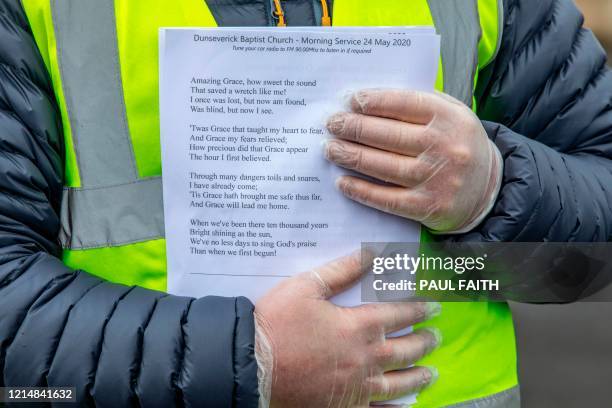 Members of Dunseverick Baptist Church wearing PPE , including a face mask and gloves as a precautionary measure against COVID-19, hand out order of...