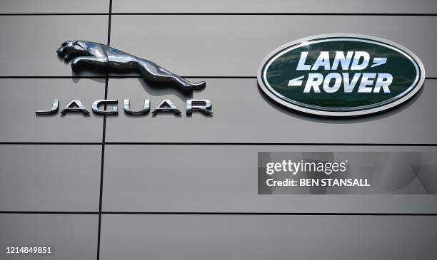 Logo is pictured outside a Jaguar Land Rover new car show room in Tonbridge, south east England, on May 24, 2020. - Jaguar Land Rover , owned by...