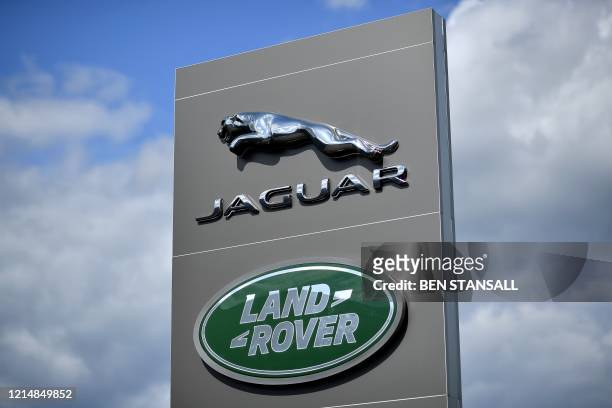 Logo is pictured outside a Jaguar Land Rover new car show room in Tonbridge, south east England, on May 24, 2020. - Jaguar Land Rover , owned by...