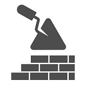 Brickwork and trowel solid icon. Spatula tool and building brick wall symbol, glyph style pictogram on white background. Construction sign for mobile concept or web design. Vector graphics.