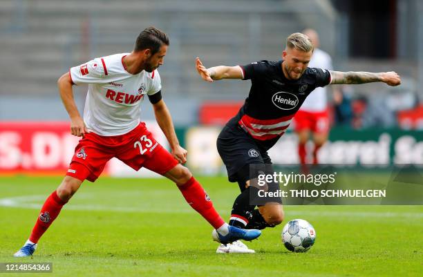 Cologne's German forward Mark Uth and Fortuna Duesseldorf's German defender Andre Hoffmann vie for the ball during the German first division...