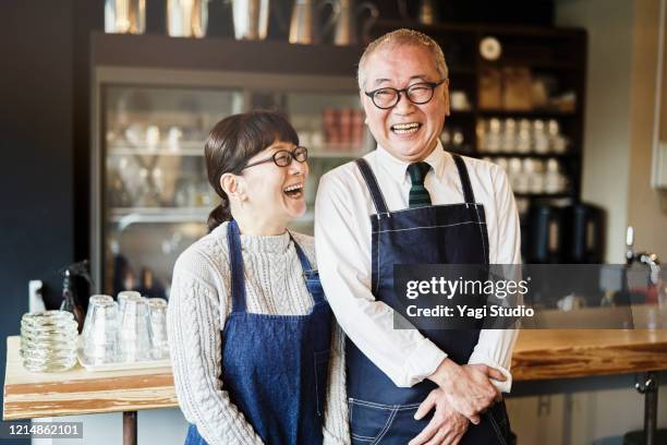 senior couple cafe owners working in cafe together - japanese old man foto e immagini stock