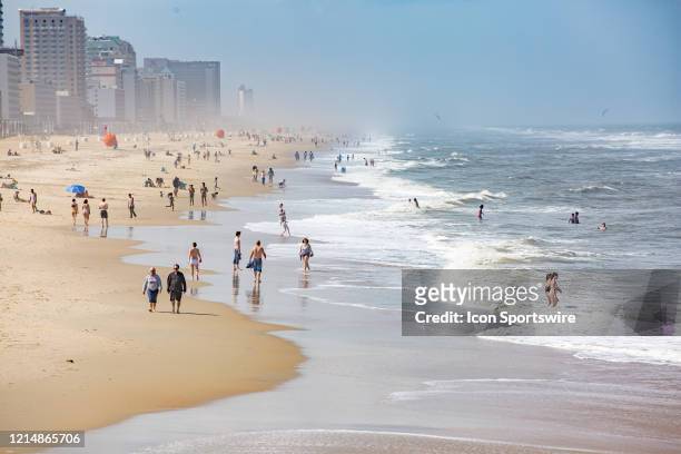 Beachgoers practice social distancing while enjoying Memorial Day weekend on May 22 in Virginia Beach, VA. This is the first day of the beach's...