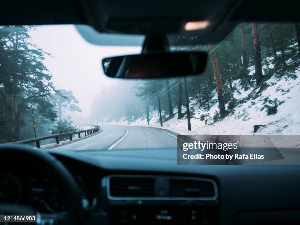 driving through snowy landscape - winter car window stock-fotos und bilder