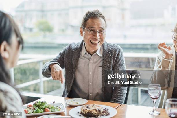 senior friends enjoying retirement party in cafe - japanese fat man bildbanksfoton och bilder