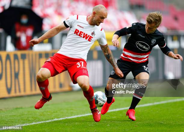 Cologne's Toni Leistner in action with Fortuna Dusseldorf's Jean Zimmer during the Bundesliga match between 1. FC Koeln and Fortuna Duesseldorf at...