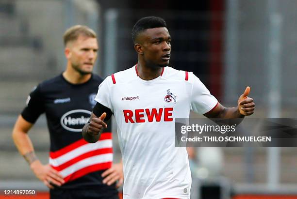 Cologne's Colombian forward Jhon Cordoba celebrates scoring the 2-2 goal during the German first division Bundesliga football match FC Cologne v...