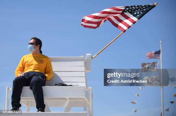 Lifeguard wear a mask while guarding the East Hampton Main Beach during Memorial Day Weekend on May 24, 2020 in East Hampton, New York. Memorial Day...