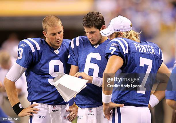 Mike Hartline, Dan Orlovsky#6 and Curtis Painter of the Indianapolis Colts look at play sheets during the game against the Washington Redskins at...