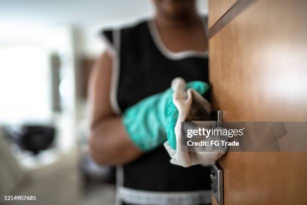 hands with glove wiping doorknob - disinfection service stock pictures, royalty-free photos & images