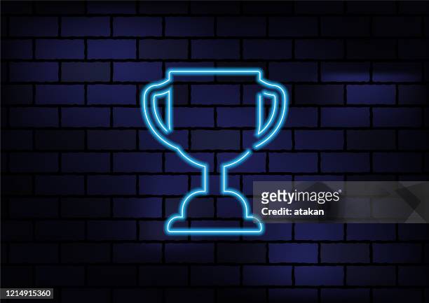 illustrazioni stock, clip art, cartoni animati e icone di tendenza di trofeo premio segno luce al neon blu su muro di mattoni scuri - grafiche neon oro