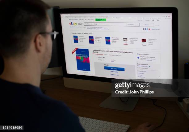 In this photo illustration a man looks at Hydroxychloroquine medication available on Ebay on March 26, 2020. The Coronavirus pandemic has spread to...