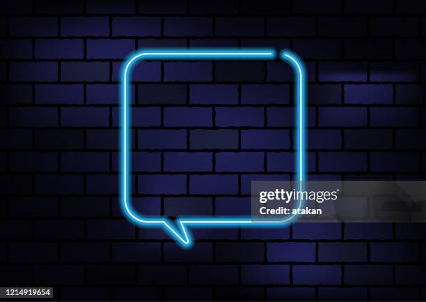 speech bubble sign blue neon light on dark brick wall - neon speech bubble stock illustrations