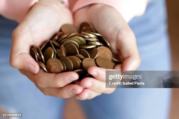 woman holding euro cent coins on hands - 年 ストックフォトと画像