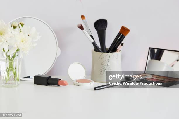 flowers and make-up on white table - compact bildbanksfoton och bilder