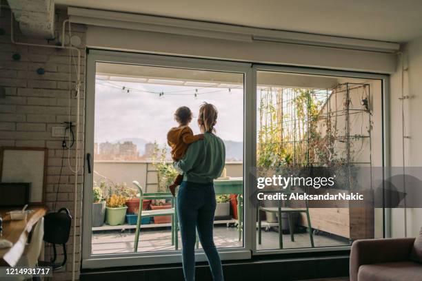 little boy in mother's arms - apartamento tipo loft imagens e fotografias de stock