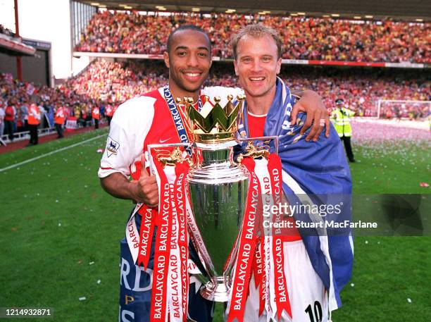 Thierry Henry and Dennis Bergkamp of Arsenal with the Premier League Trophy after the Premier League match between Arsenal and Leicester City on May...