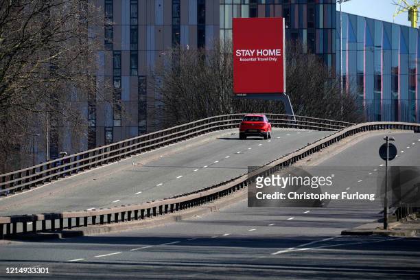 Giant television over the A57 Motorway screen urges people to stay home on March 26, 2020 in Manchester, England. British Prime Minister, Boris...