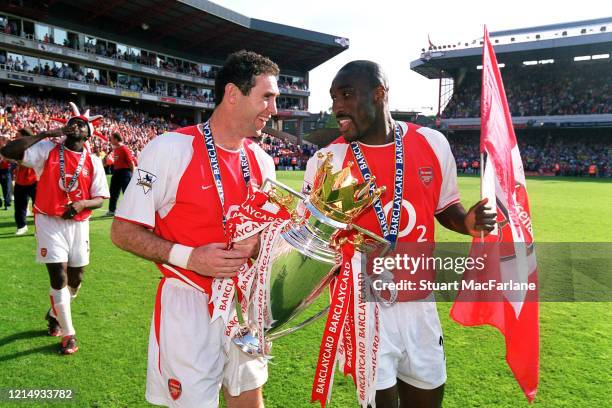 Martin Keown and Sol Campbell of Arsenal with the Premier League Trophy after the Premier League match between Arsenal and Leicester City on May 15,...