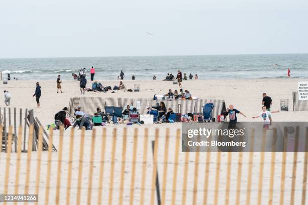 People gather at Jones Beach in Wantagh, New York, U.S., on Sunday, May 24, 2020. New York expects a "controlled" increase in coronavirus cases as...