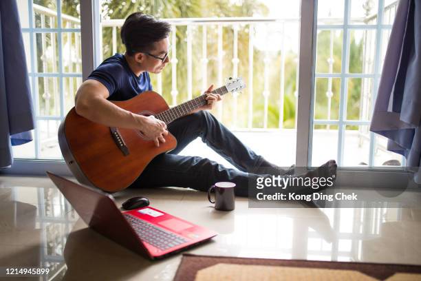 an asia chinese businessman work from home. playing guitar during coffee break time. - songwriter stock pictures, royalty-free photos & images