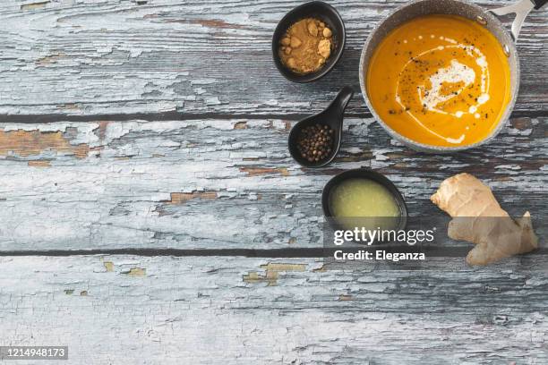 pumpkin and carrot soup with ginger - food styling soup stock pictures, royalty-free photos & images