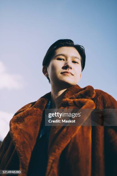 low angle portrait of woman against sky - non binary stereotypes stock pictures, royalty-free photos & images