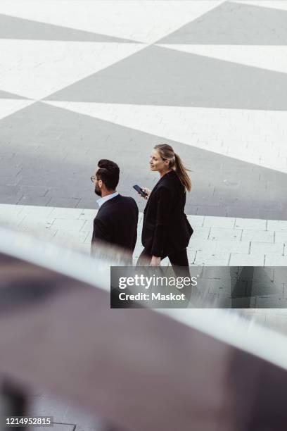 high angle view of business people walking and talking outdoors - business scandinavia stock pictures, royalty-free photos & images