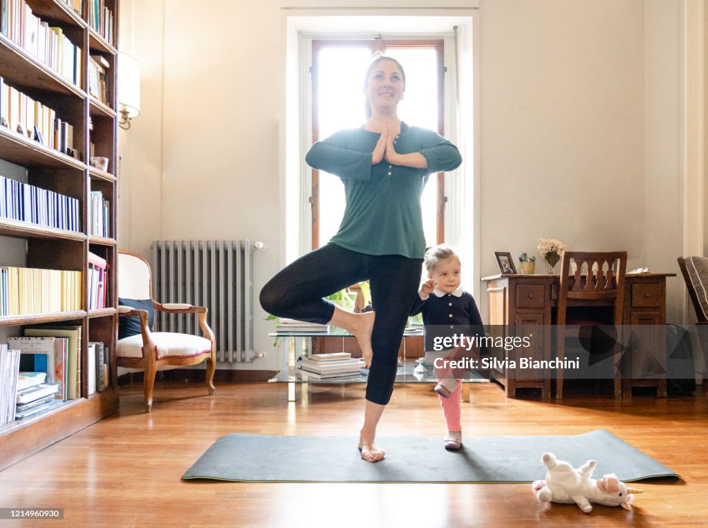 Mother and daughter doing yoga together
