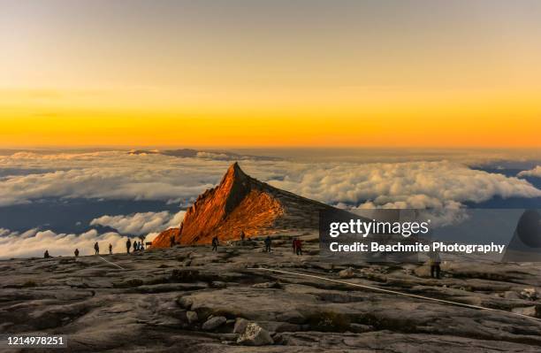 south peak ,mount kinabalu at sunrise viewed from the summit plateau - mount kota kinabalu stock pictures, royalty-free photos & images