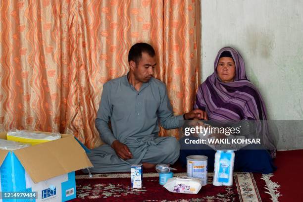 This photo taken on May 22, 2020 shows survivors of an attack by militants at a maternity ward Hasan Ali his wife Zia Gul and their newborn daughter...