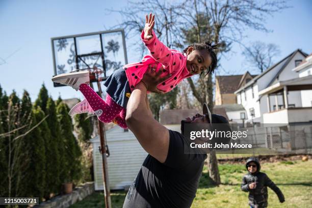 Chef Mo Major exercises in the backyard with his children Marley and Max on March 26, 2020 in Mount Vernon, New York. Mo was laid off as a chef...