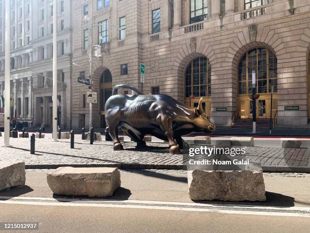 View of the 'Charging Bull' sculpture in the Financial District in New York City as the coronavirus continues to spread across the United States on...